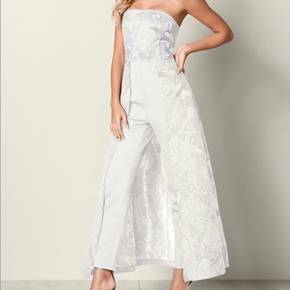 white jumpsuit with skirt overlay